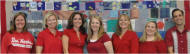 people in red shirts posing for group photo